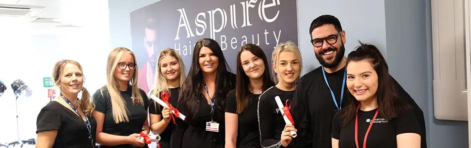 hairdressing students with their diplomas stood in a line